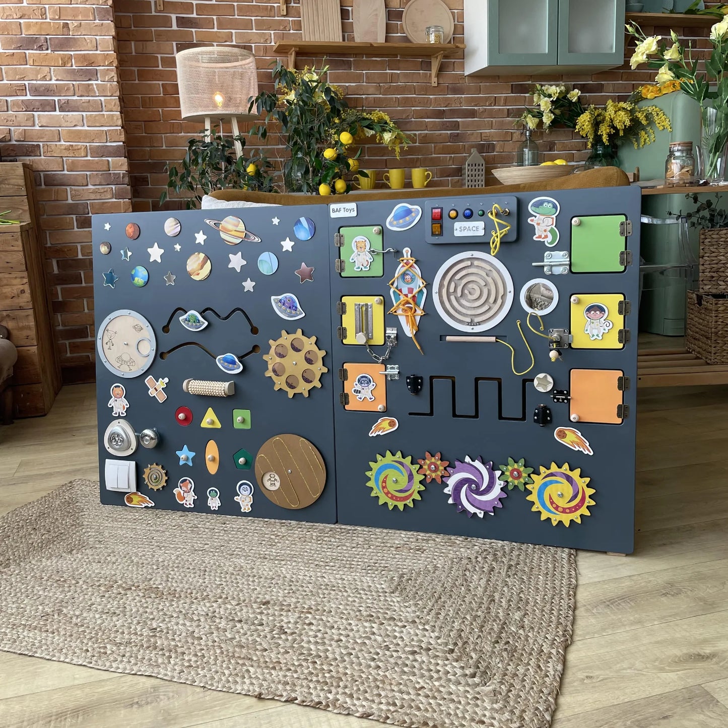 Sensory Wall Panel for Schools, Clinics & Nurseries in a Space Theme with dark grey background, designed for kids and adults with autism, featuring fine motor activities, lights, locks, gears and planets