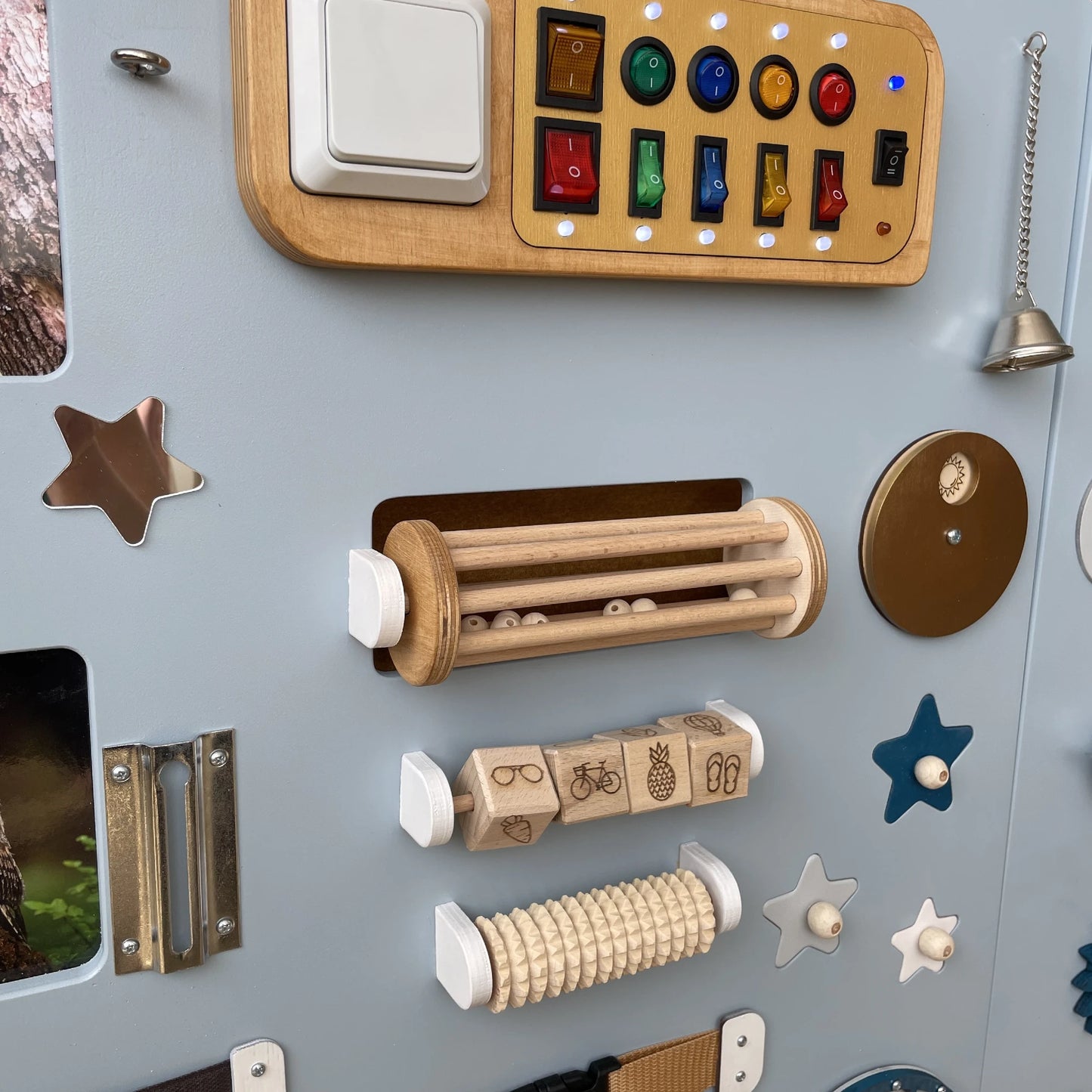 Left side close-up of sensory panel showing belts, rollers, abacus and wooden doors