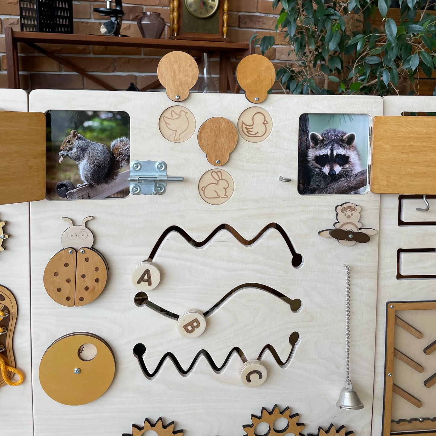 Full view of the natural wood sensory wall panel placed in an interior room setting with educational decor.