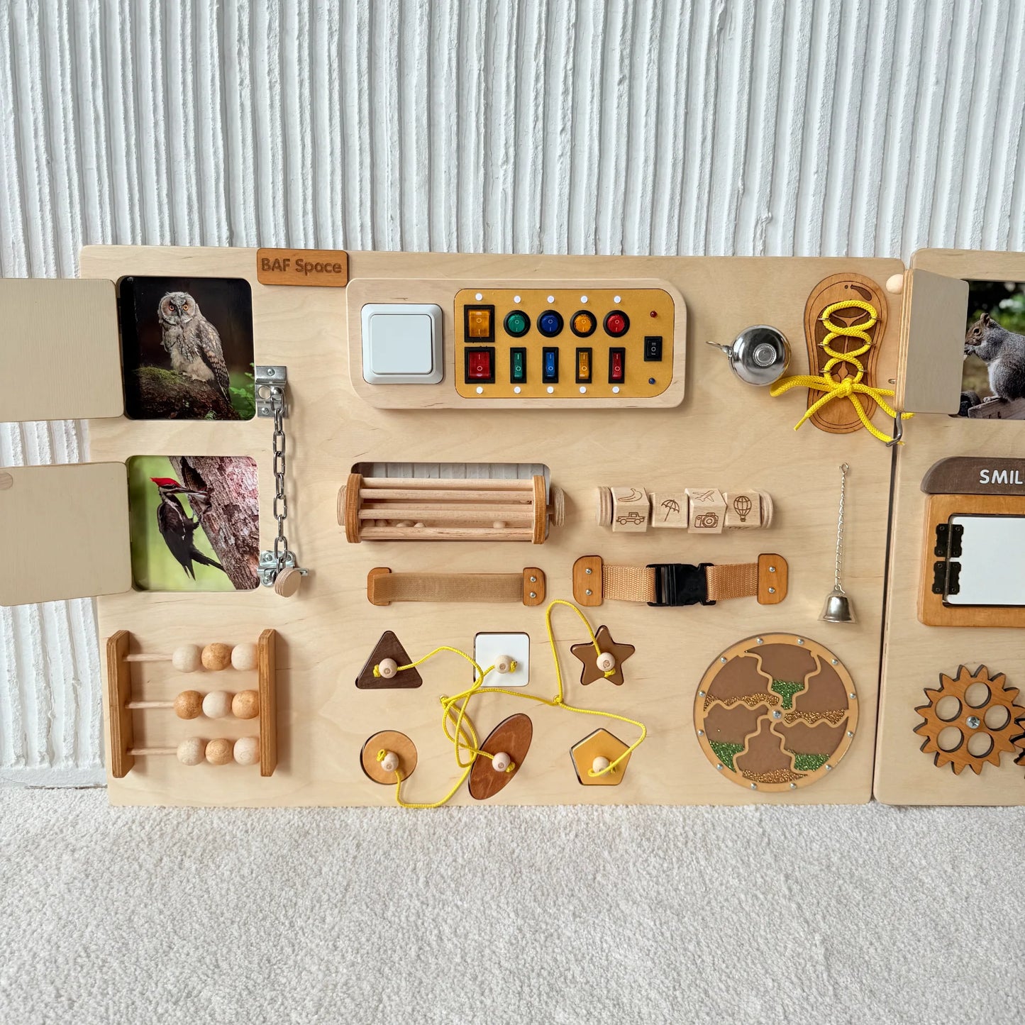Left part of large sensory wall panel with toggle switches, locks, buckles and interactive learning features