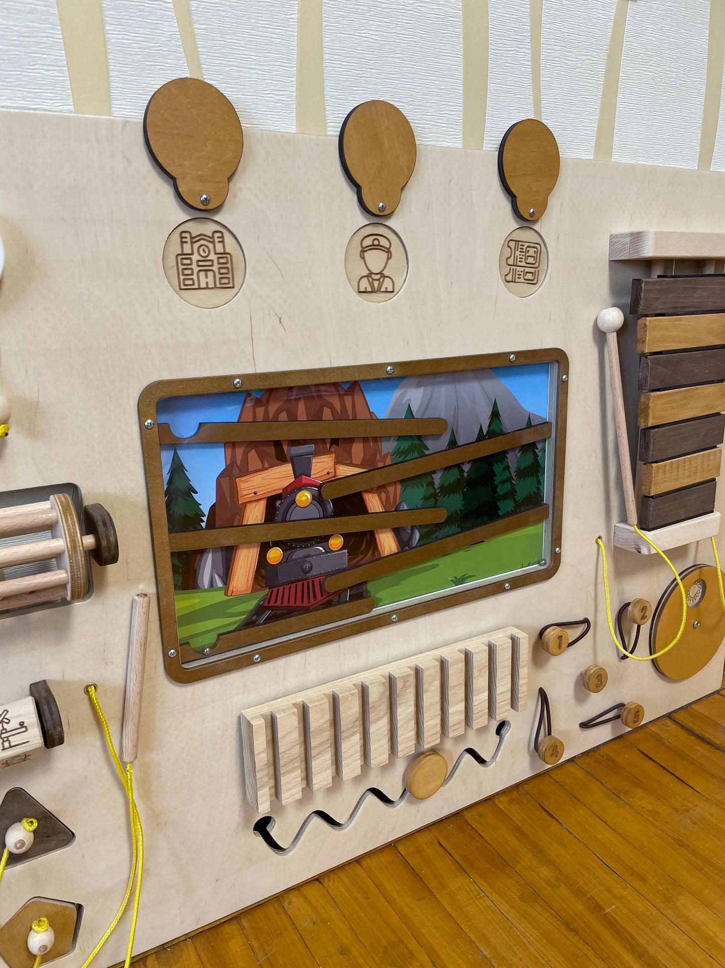 Train theme preschool sensory wall with  lacing activity. Develops cognitive and fine motor skills.