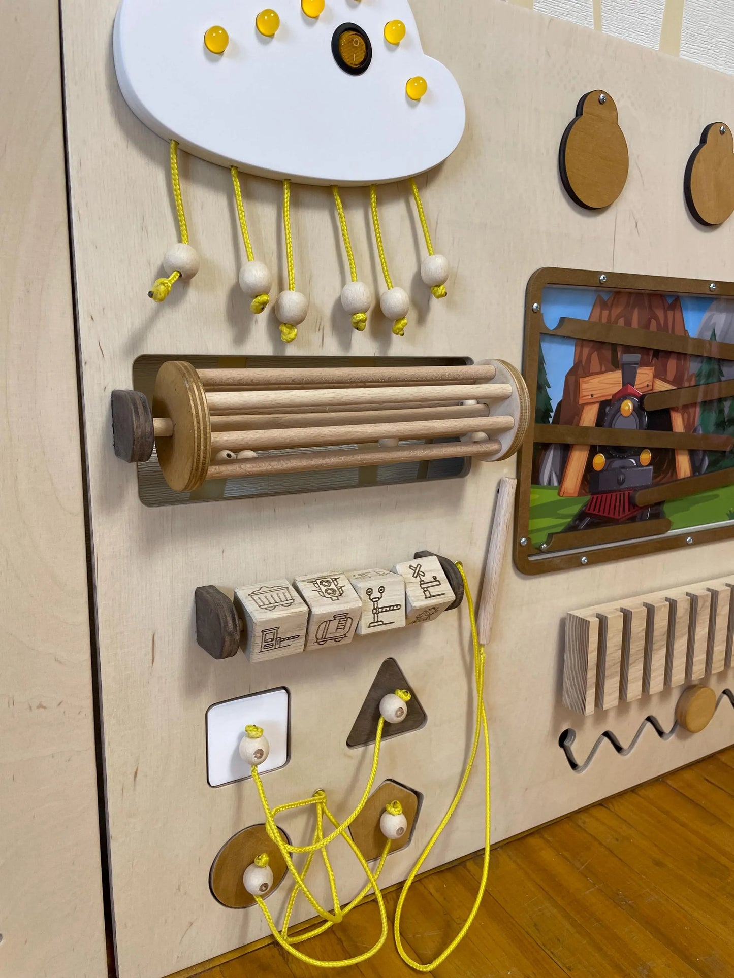 Train theme sensory wall with locks and latches. Kindergarten activity board for developing fine motor skills. 