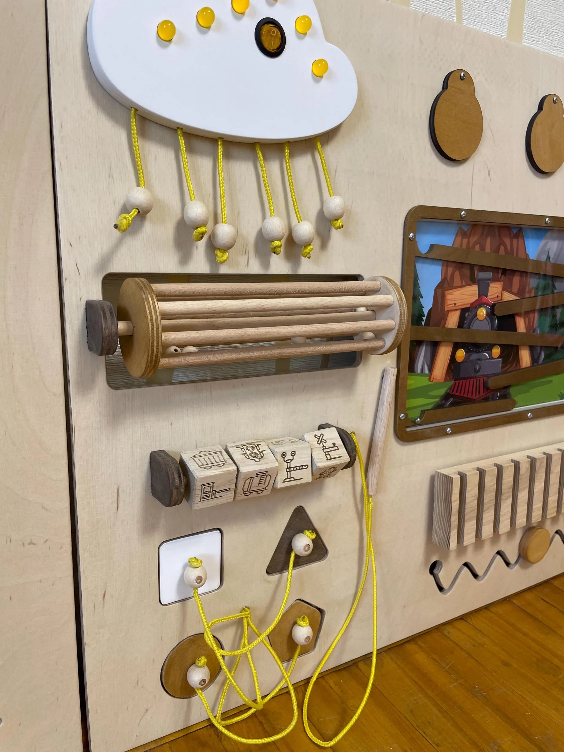 Train theme sensory wall with locks and latches. Kindergarten activity board for developing fine motor skills. 