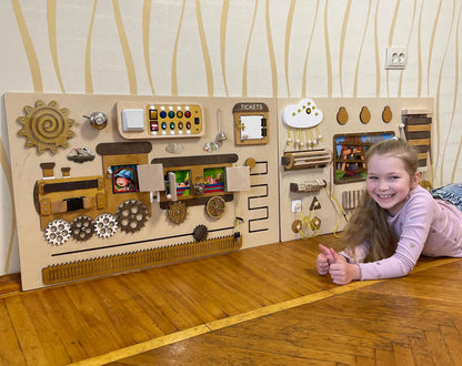 Train theme sensory wall panels in a school hallway. Sensory toys for autism and engaging classroom sensory equipment.