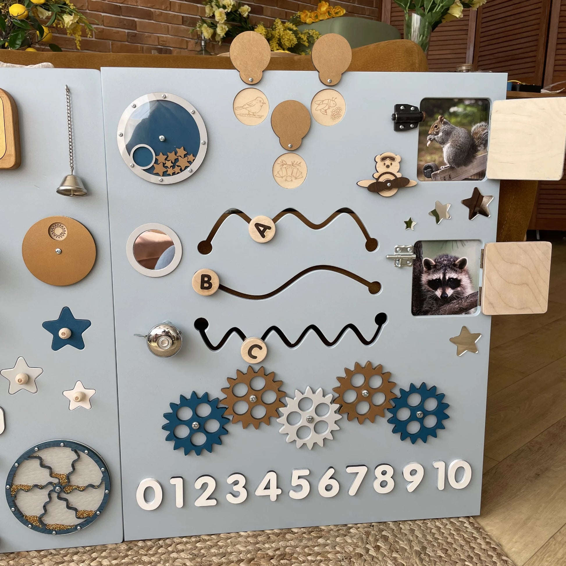 Large blue nature themed busy board ideal for kids and adults in therapy rooms or classrooms