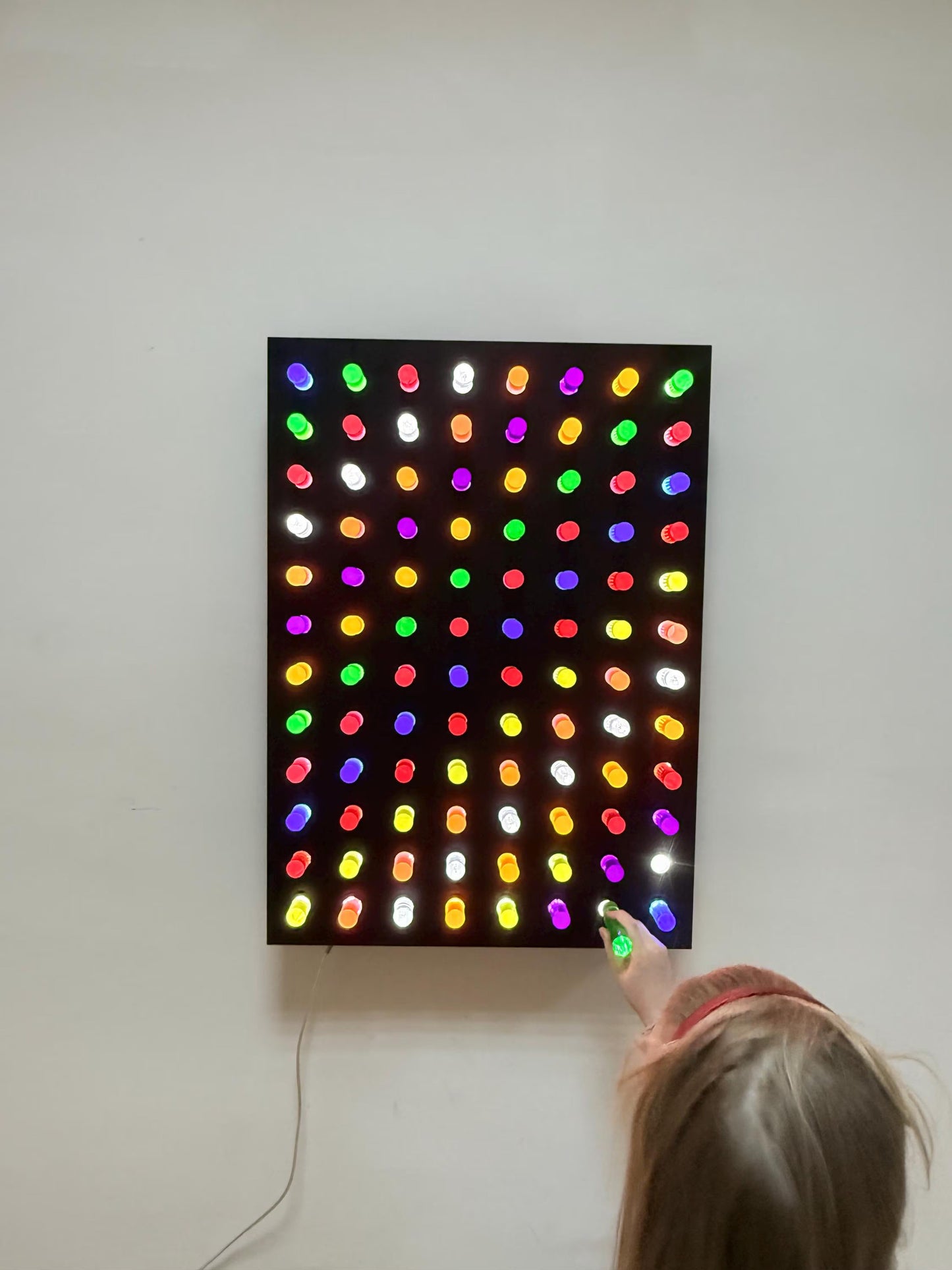 Child placing colorful acrylic rods into Giant Light Peg Board With Acrylic Rods | Light Panel Sensory Wall – LED sensory wall panel for fine motor skills and focus development
