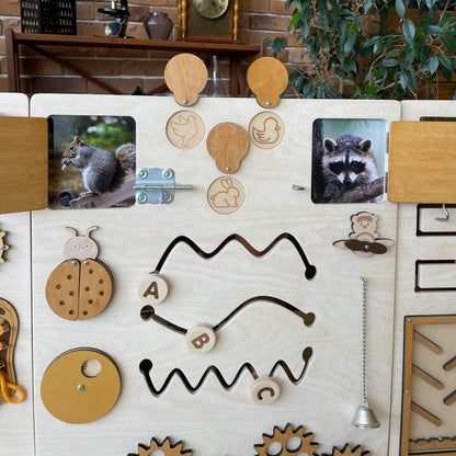 Full view of the natural wood sensory wall panel placed in an interior room setting with educational decor.