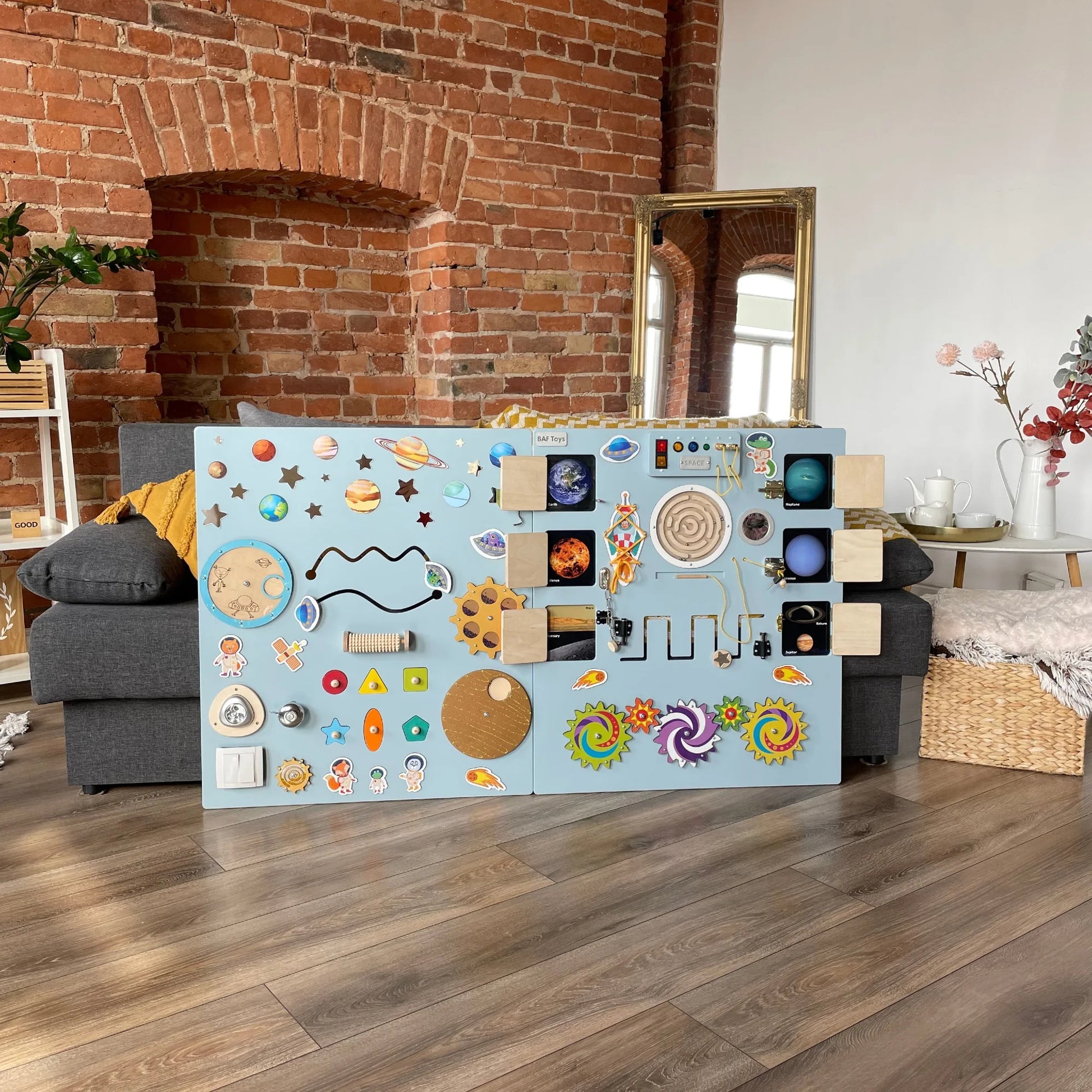 Large space-themed sensory wall panel – Sky Blue. Includes opening doors, LED lights, switches, and interactive elements for fine motor skills and logic
